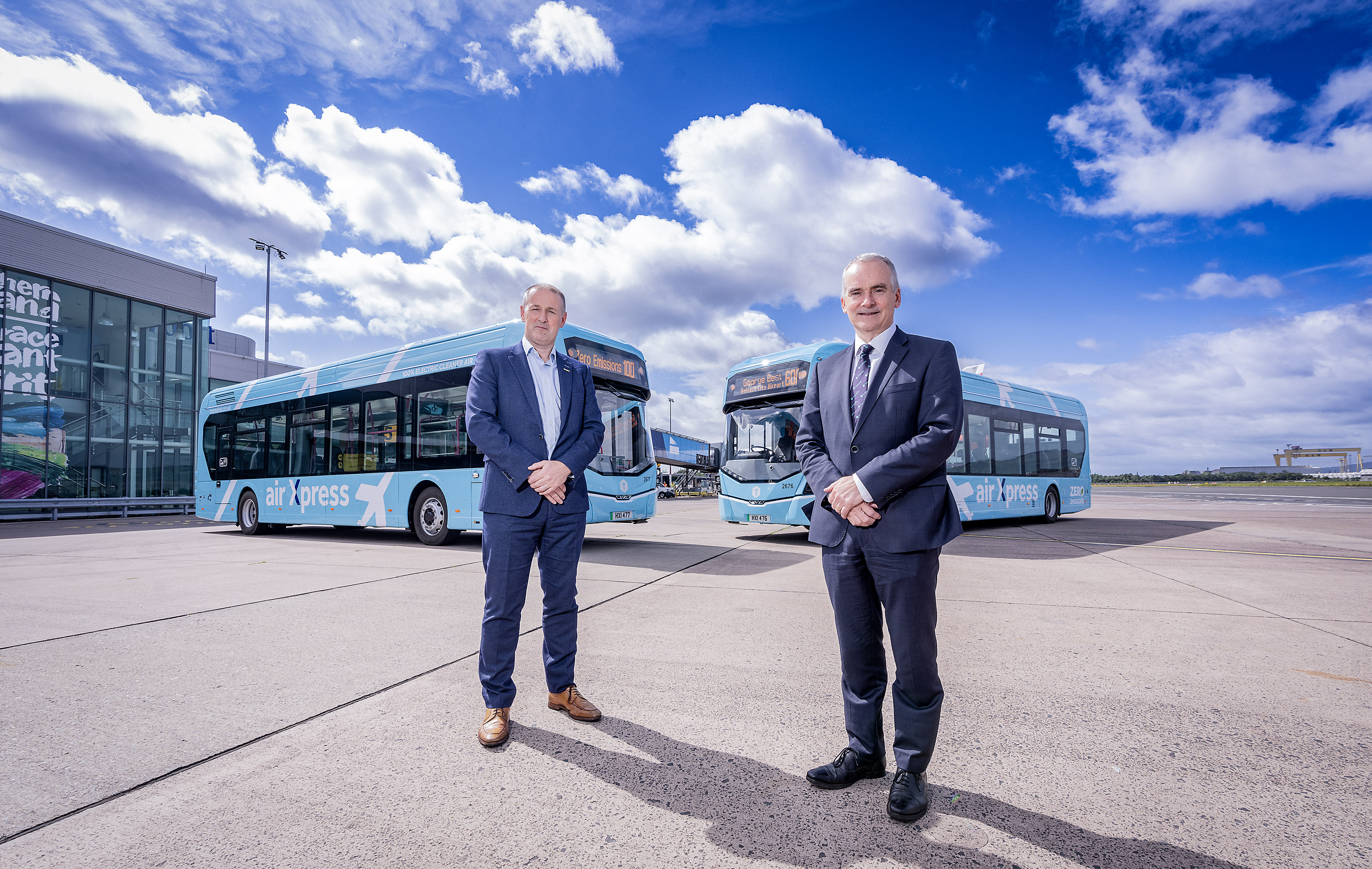 Translink Chief Executive, Chris Conway, with two zero emissions buses at Belfast City Airport