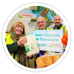 Translink present Fareshare staff with items for food bank collection